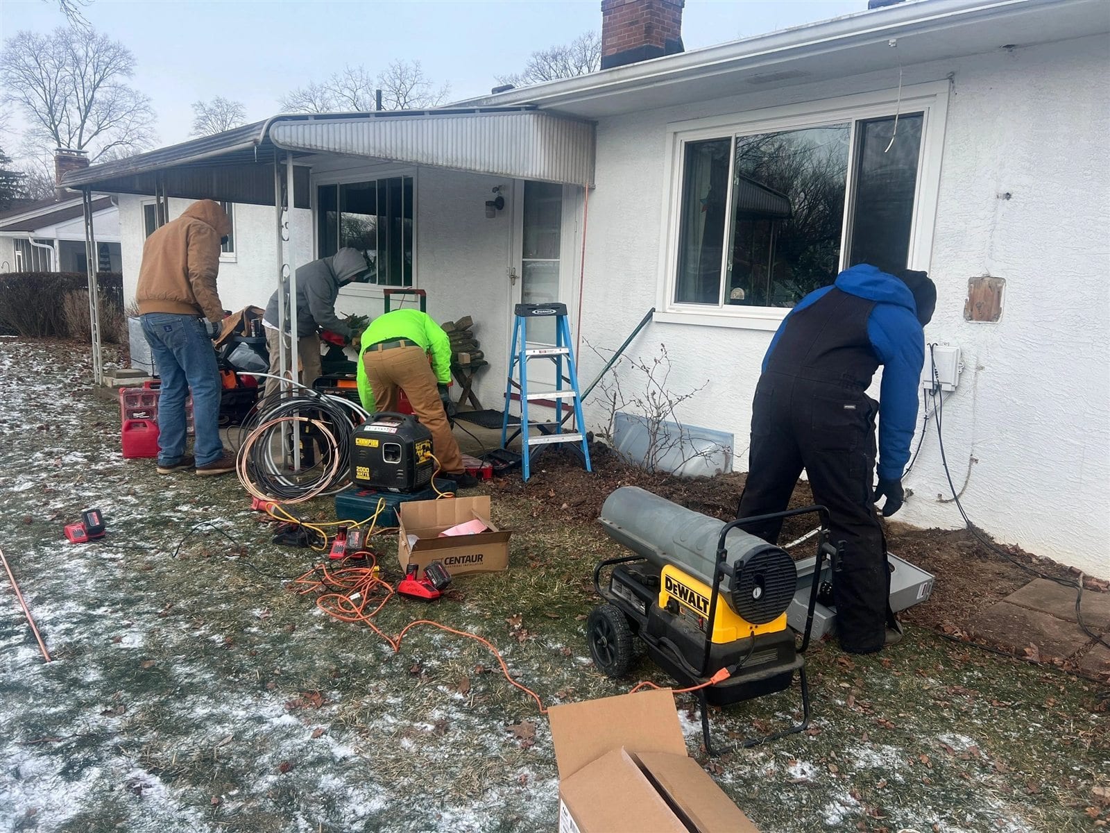 Buckeye Electric crew performing outdoor electrical service work at a Central Ohio home in winter